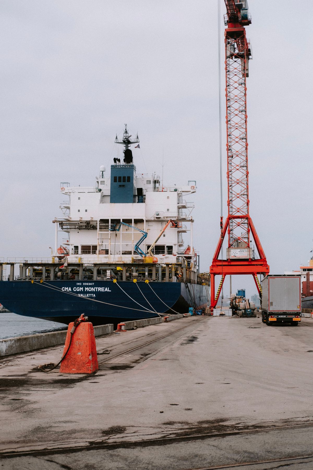 Truck delivering supplies to a cargo ship at port
